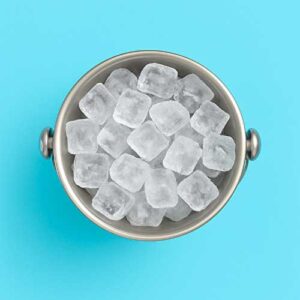 A metal bucket filled with ice cubes is viewed from above, set against a solid light blue background.